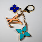 Orange LV pendant with turquoise and dark blue flower charms