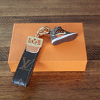 Brown sneaker keychain showing sole and gold-tone strap fitting