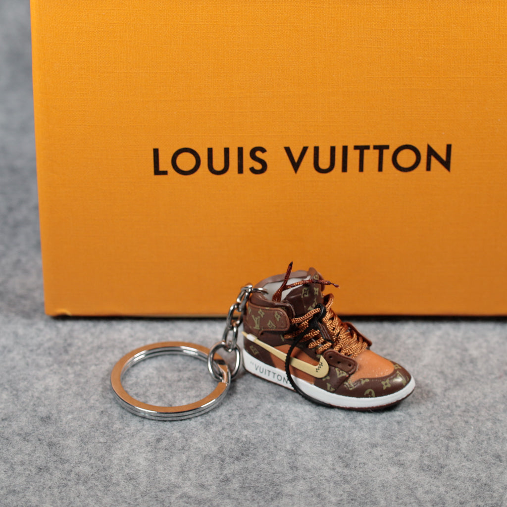 Brown high-top sneaker charm shown beside its round keyring