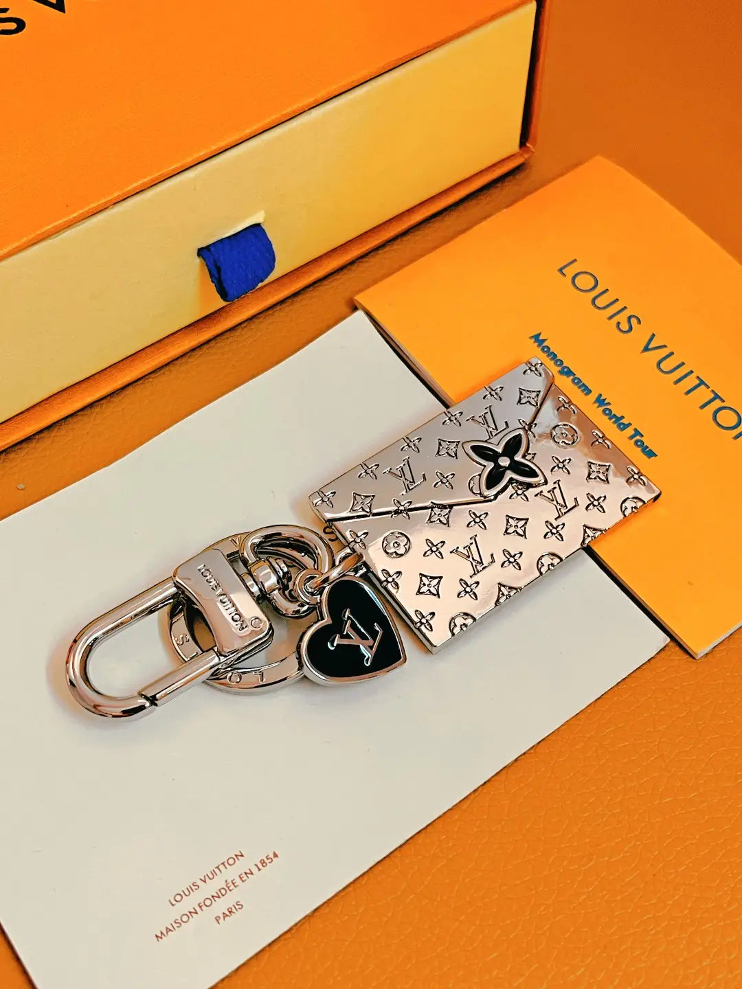 Envelope keychain with black flower and heart charms