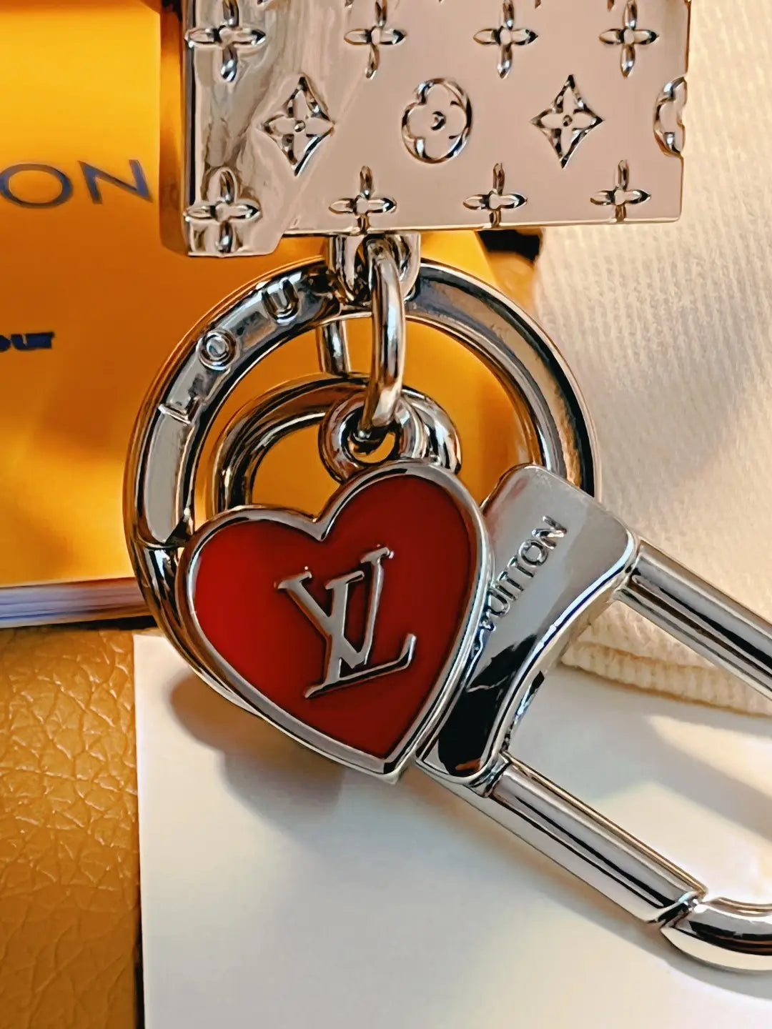 Close-up of red LV heart charm and connecting keyring