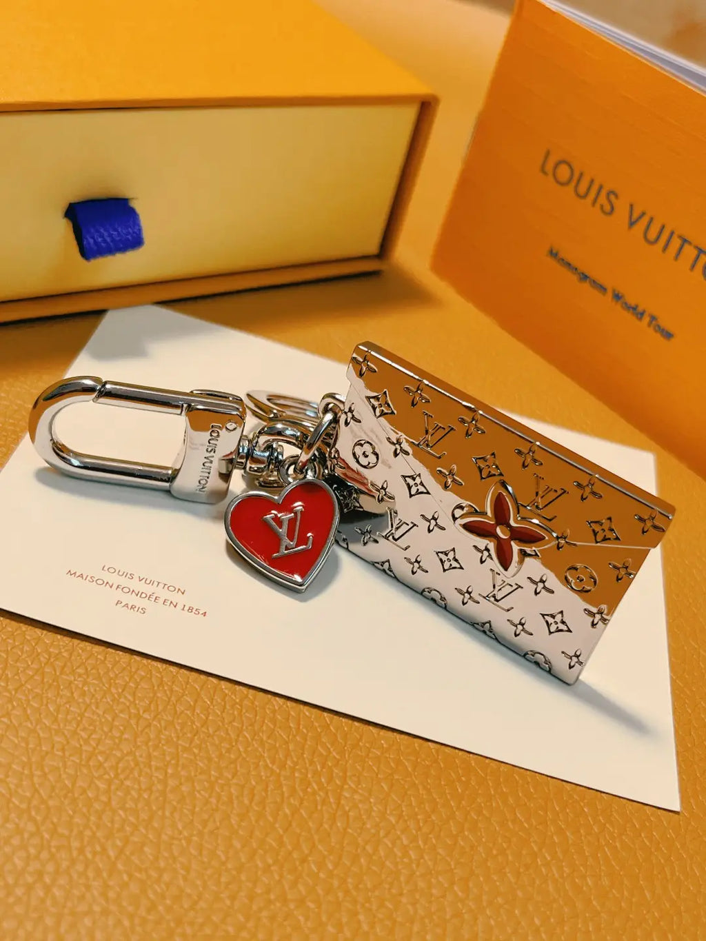 Red-accented envelope keychain with polished silver-tone clasp