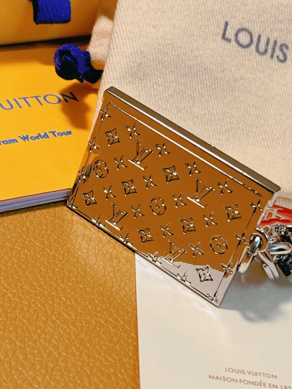 Reflective envelope keychain showing patterned reverse and folded edge