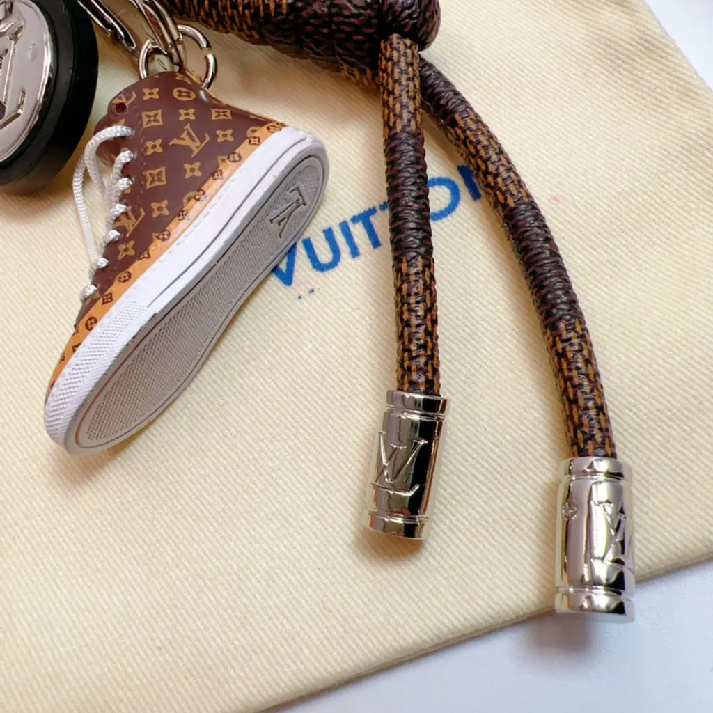 Brown sneaker charm showing pale sole and patterned cord ends