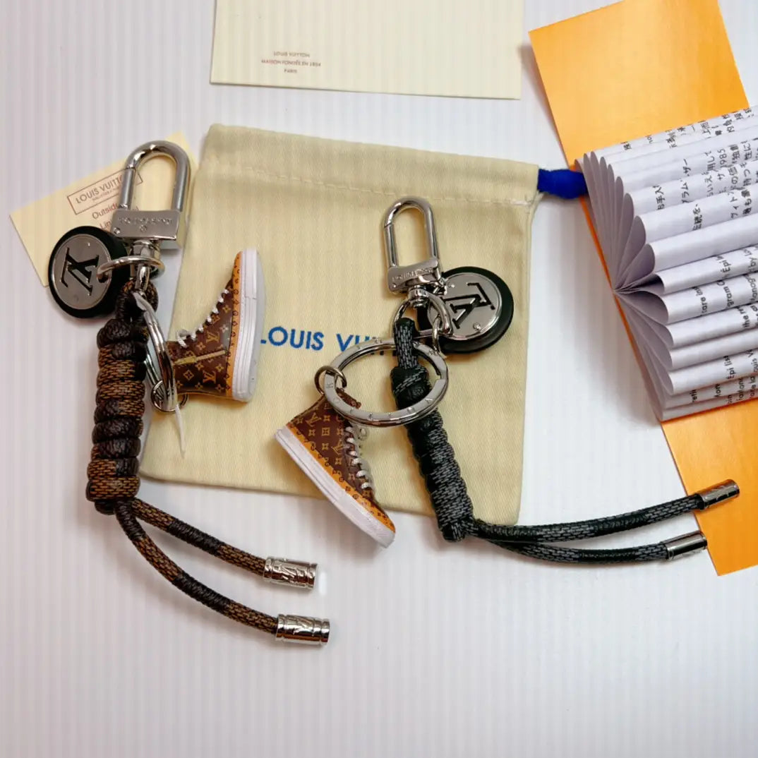 Brown and dark sneaker keychains with cords and round pendants
