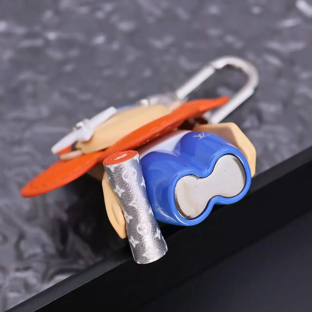Underside of Vivienne keychain showing blue base and silver-tone detail