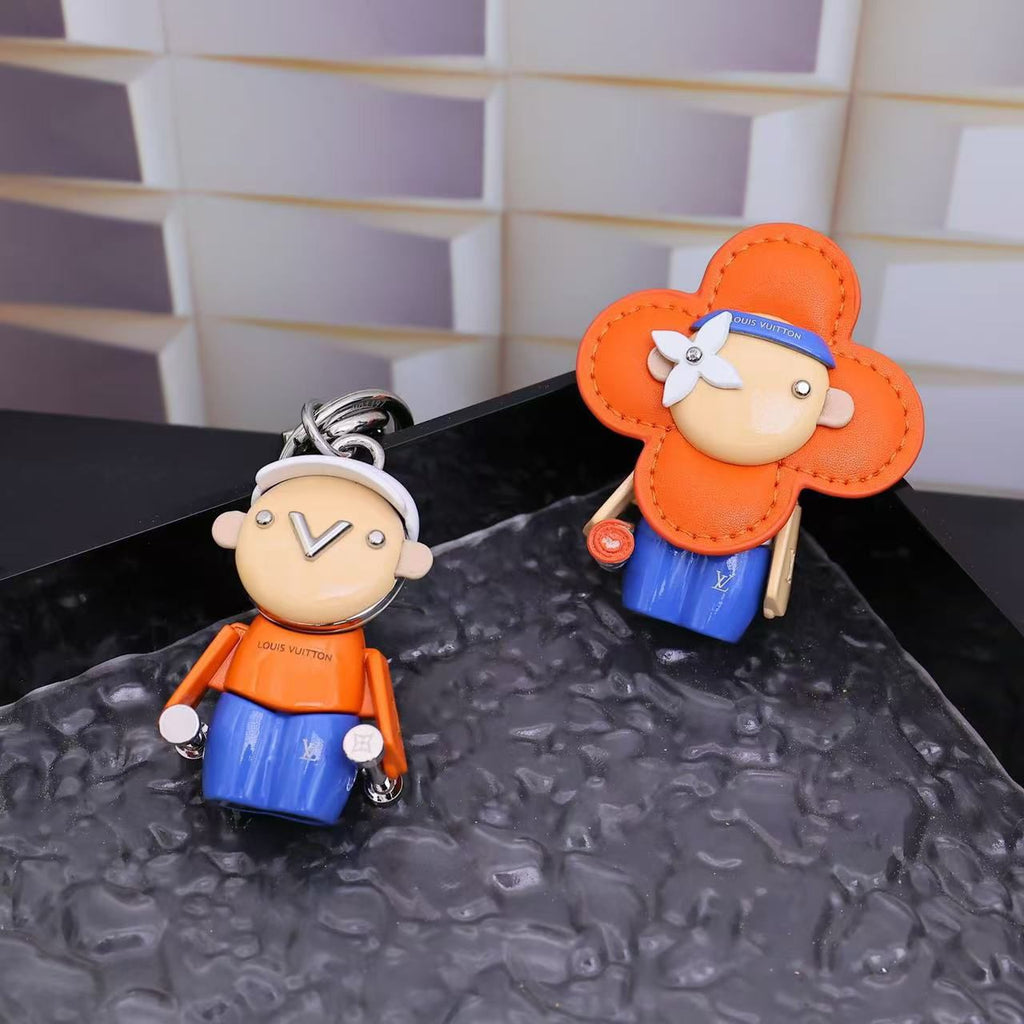 Orange Vivienne flower charm displayed beside its matching character