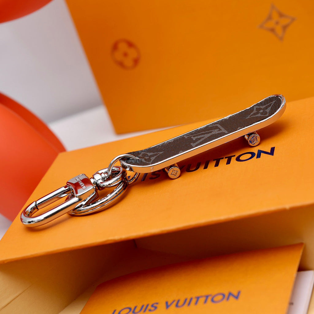 Brown monogram skateboard charm shown with its tiny wheels