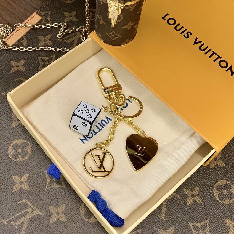Cube keychain showing gold-tone heart backing and round LV charm