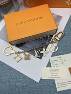 Full-length gold-tone ornament chain displayed below an orange box