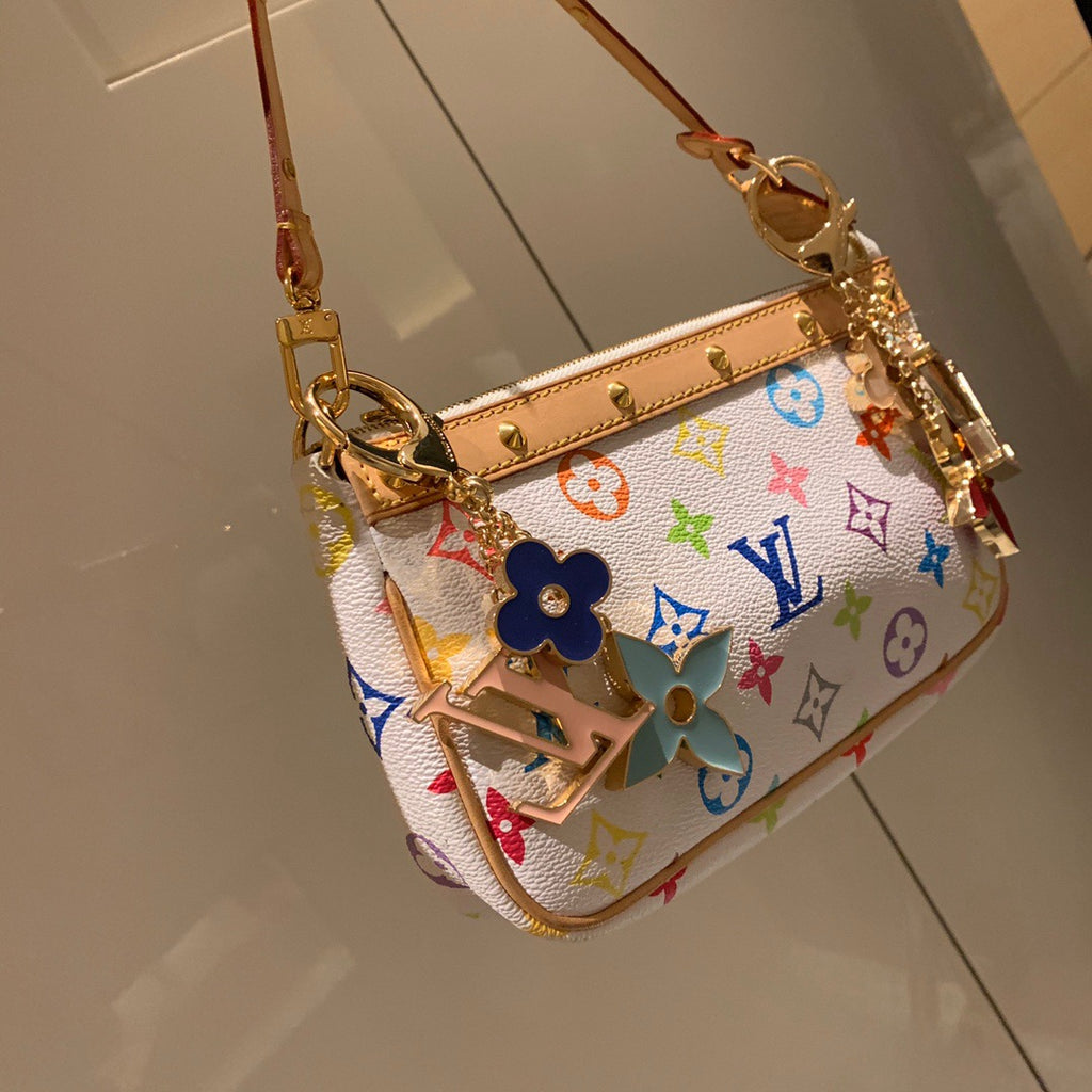 Bright floral LV keychain attached to a white multicolor bag
