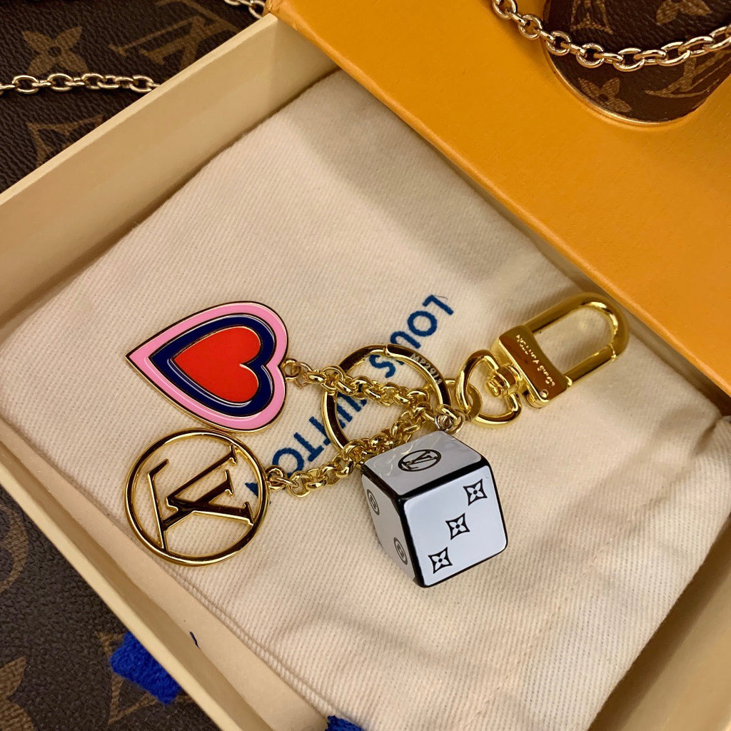 Close-up of red heart and white cube charms in packaging