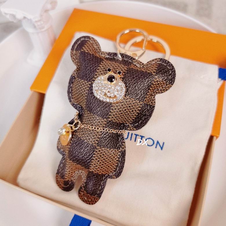 Checkered bear charm resting on a pouch inside a box