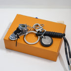 Sneaker keychain showing laces, round pendant, and braided cord
