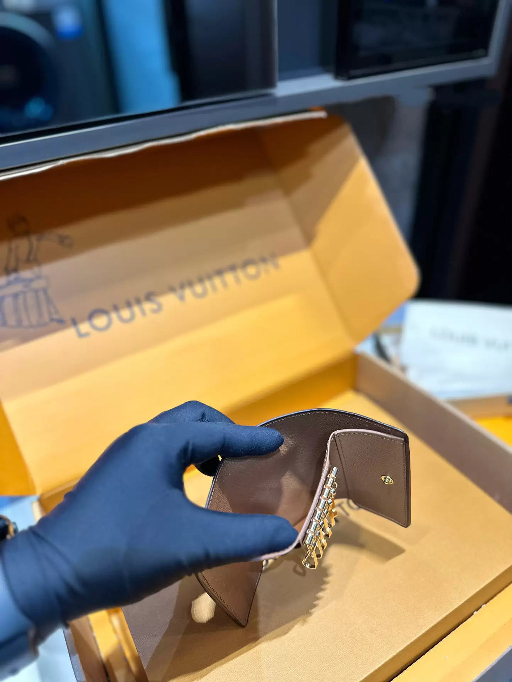 Side view of opened key holder showing folding panels