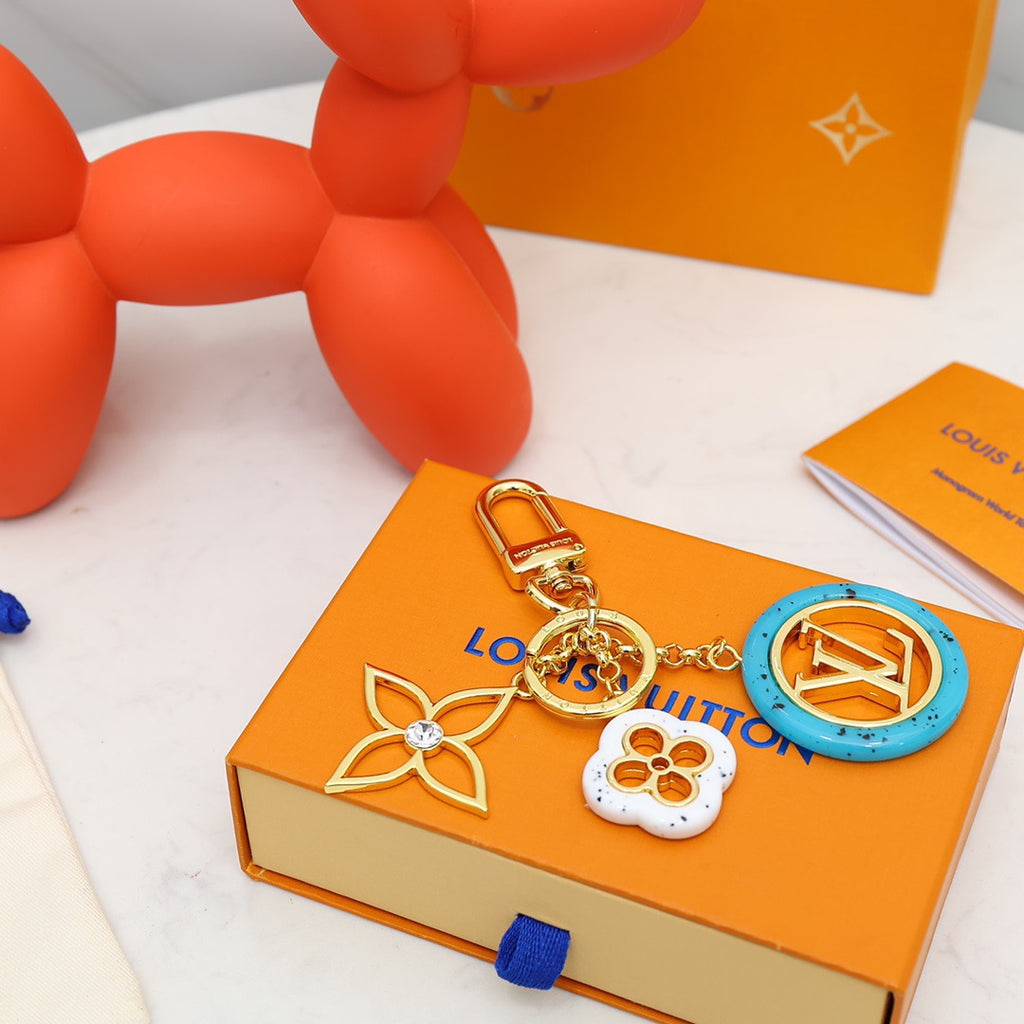 Blue LV medallion and white flower keychain on orange packaging