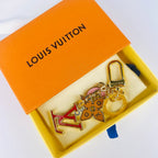 Red LV monogram keychain resting in an open orange box