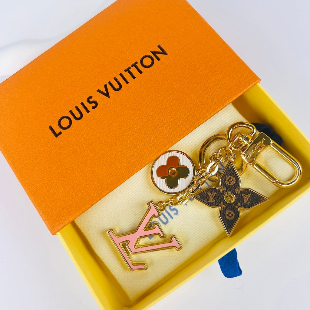 Pink LV monogram keychain displayed inside an orange box